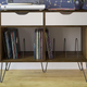 This mid-century modern console is designed specifically for everything vinyl: it holds both your turntable and your entire collection. It comes in multiple sizes and colors as well.
